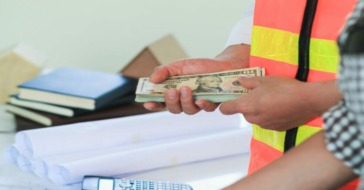 Image showing a contractor being paid with US currency notes.