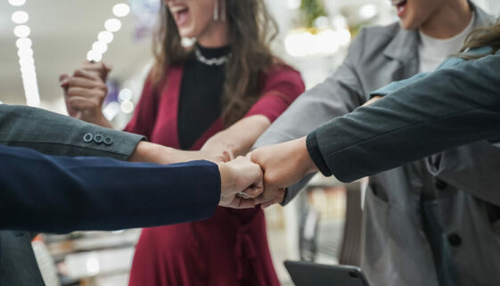 People shaking hands together showing sign of a thriving community