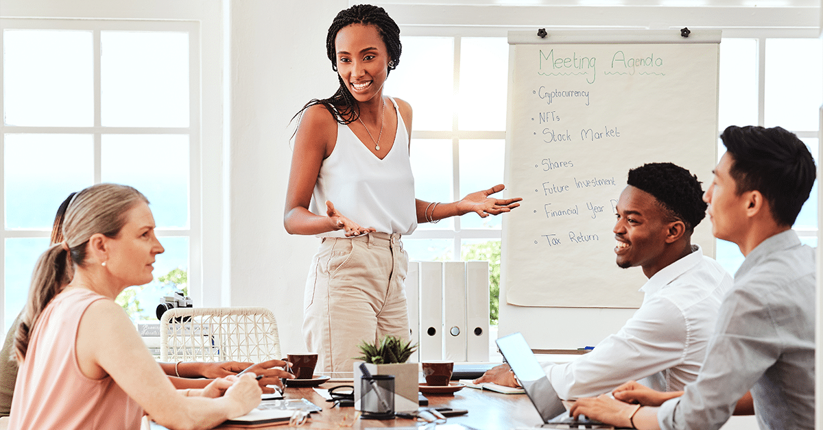 A woman in leading role at an corporate showing how to coach employees for optimal performance