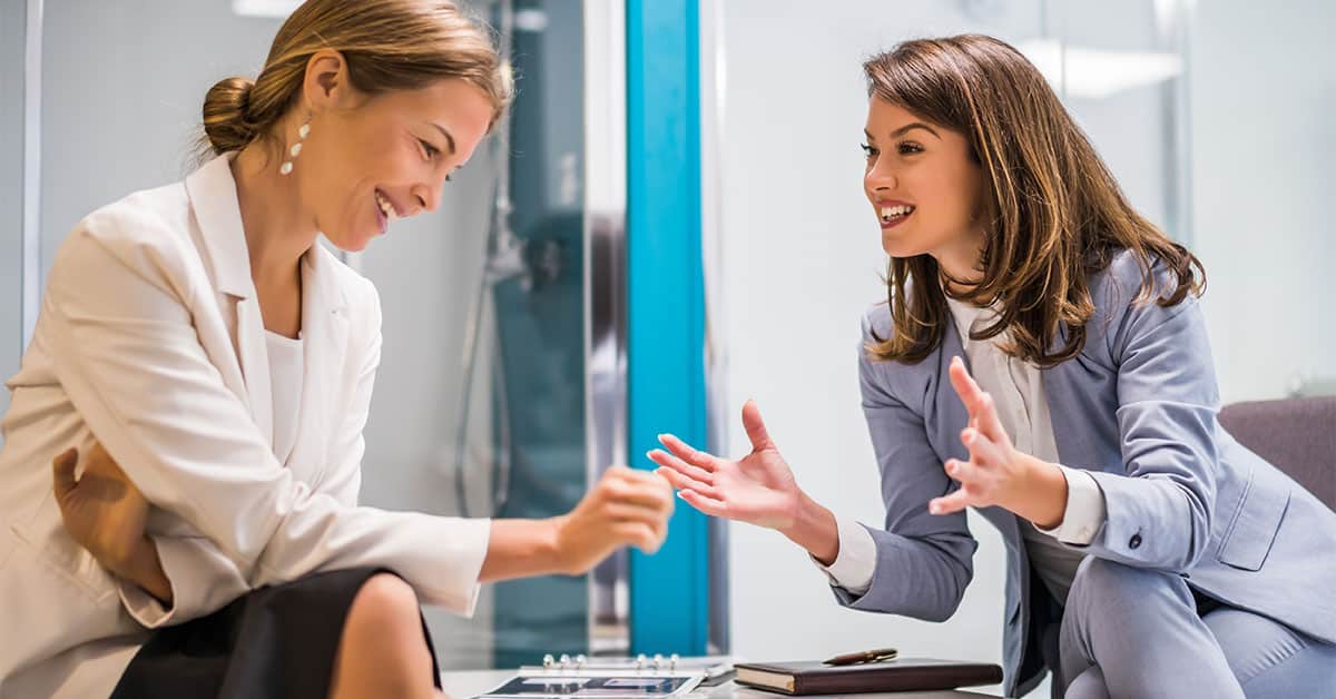 An image of a salesperson talking with a customer, to symbolize the idea of building relationships and creating a positive sales experience.